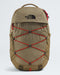 The North Face Sortlis backpack in a warm khaki-tan color, featuring red compression straps across the front and a black embroidered logo on the upper front panel, set against a light gray studio background.
