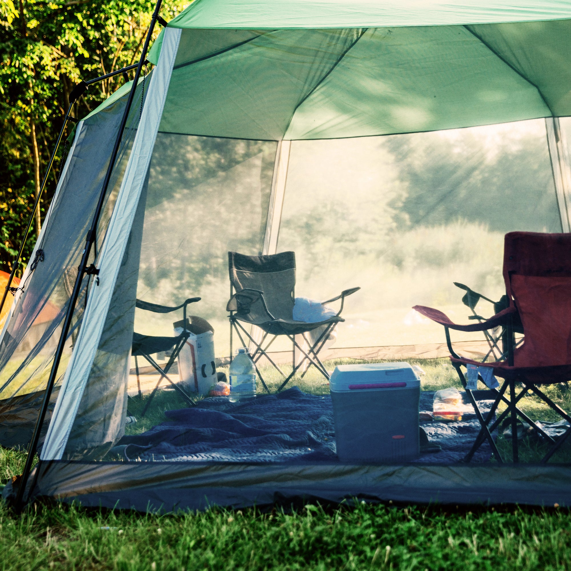 camping set up with tents and chairs
