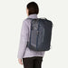 Person wearing a Patagonia backpack on a plain background