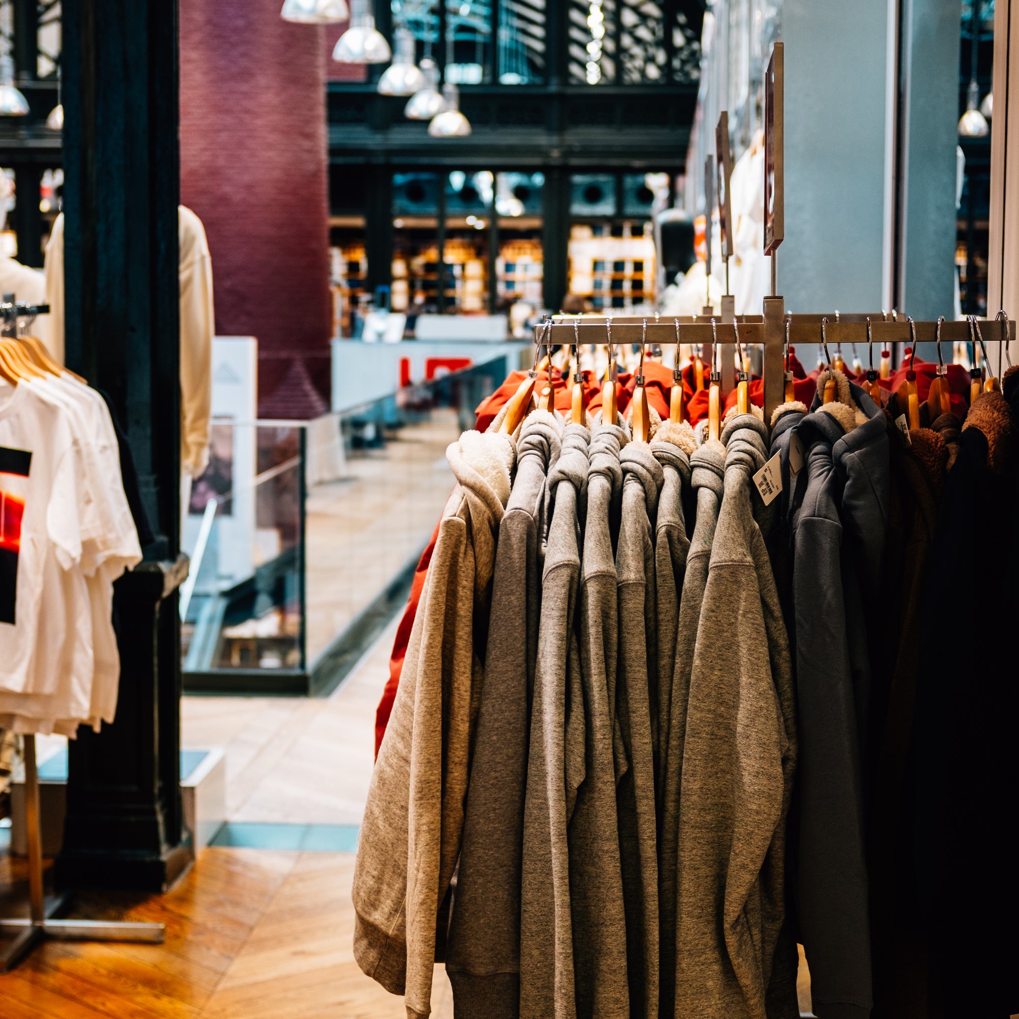 the-inside-of-a-store-with-grey-sweaters-stacked