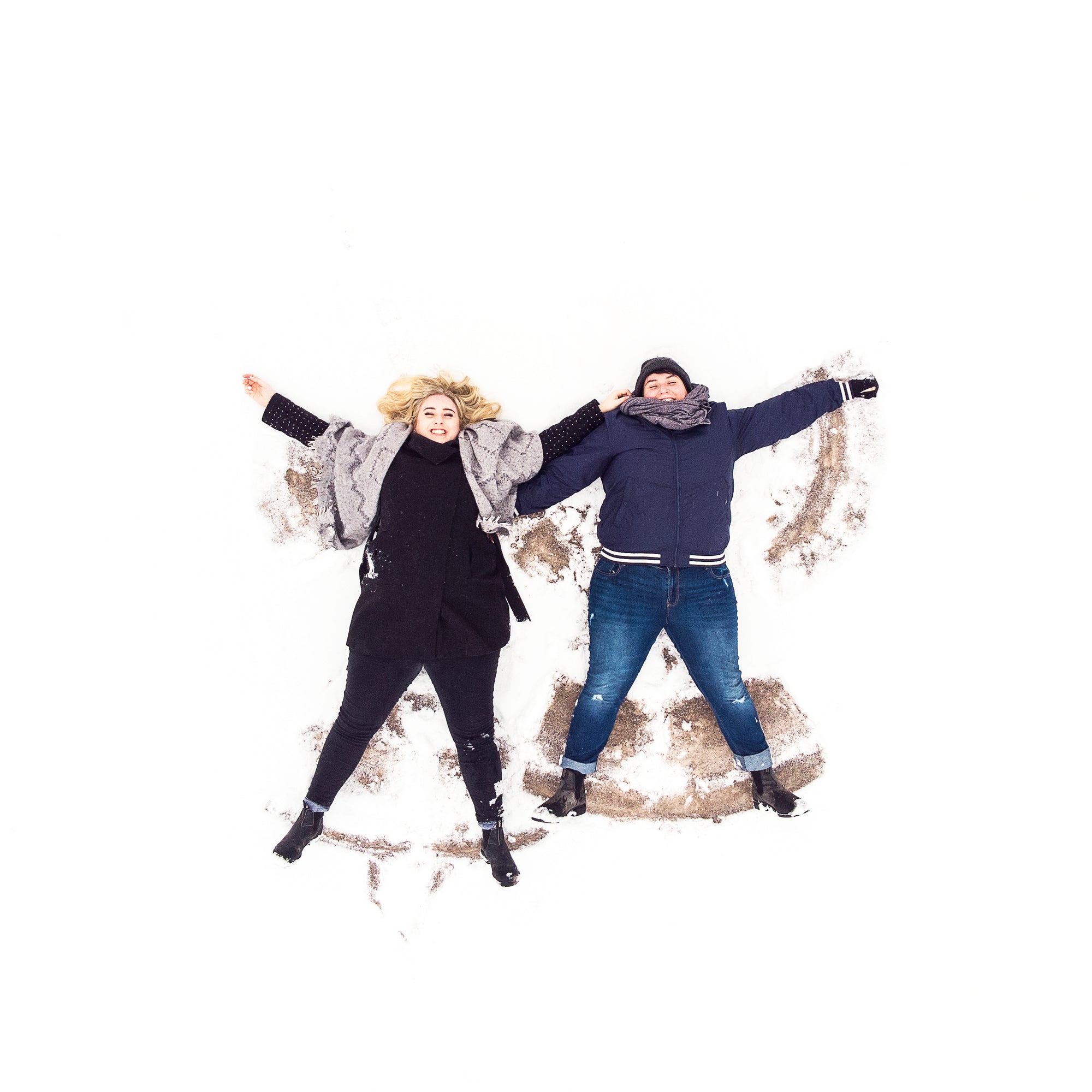 two-women-on-their-backs-in-the-snow